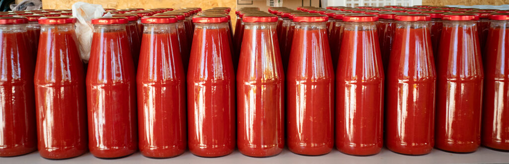 Bottles of homemade tomato souce alligned