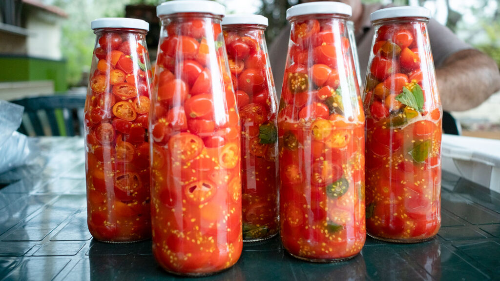 Cherry tomatoes in glass bottles