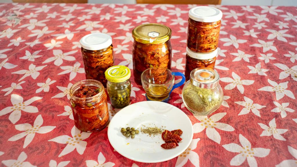 Sundried tomatoes stored in glass jars on the kitchen table